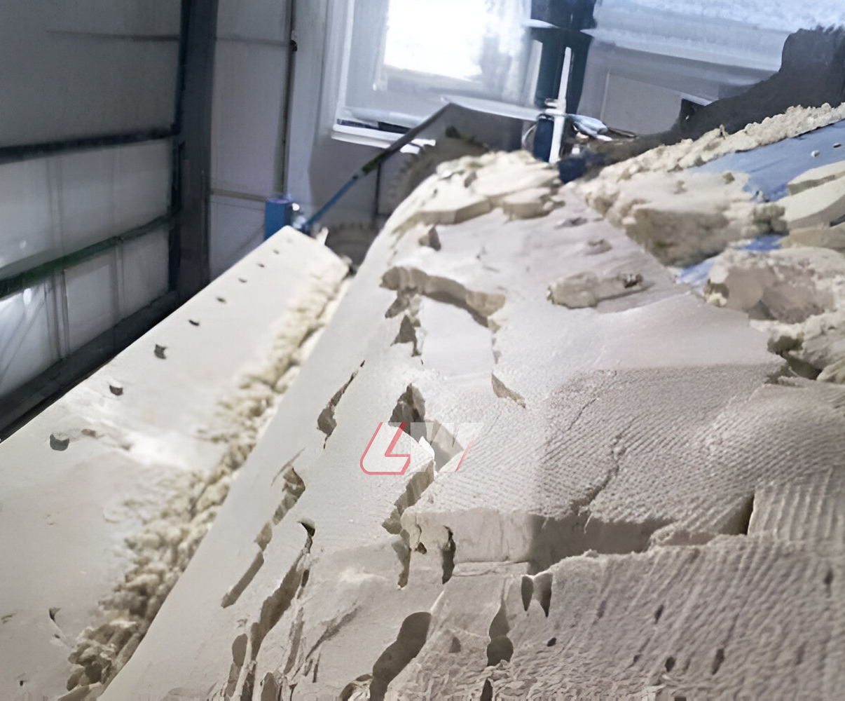 Dewatered cake in large cracked plates lifting off the filter cloth of a vacuum belt filter press