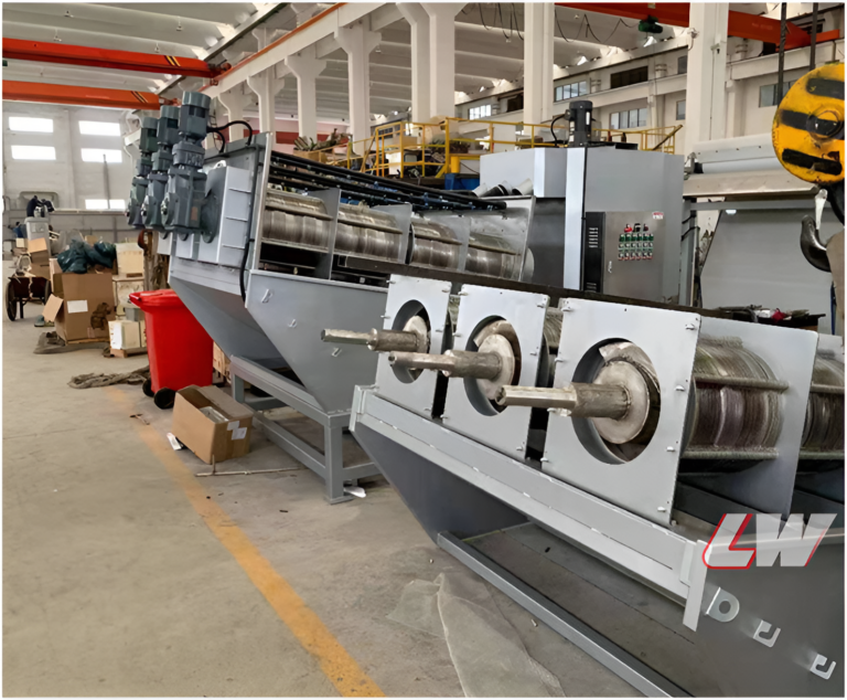 Multi-disc screw press on the workshop floor with overhead crane