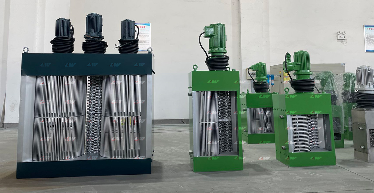 Loway factory floor with a navy-frame twin-shaft grinder and multiple green-shell units lined up for shipment.