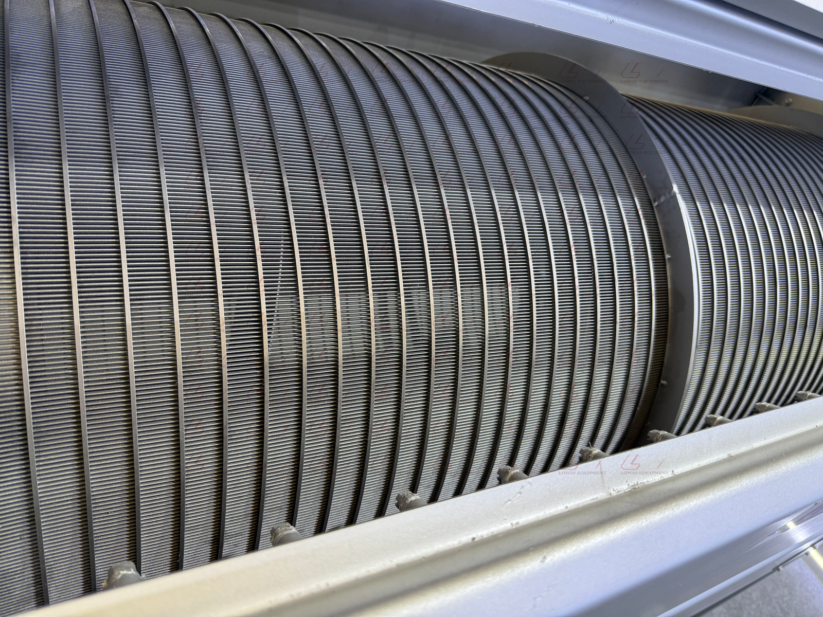 Close view of the wedge-wire mesh surface on a Loway rotary drum filter
