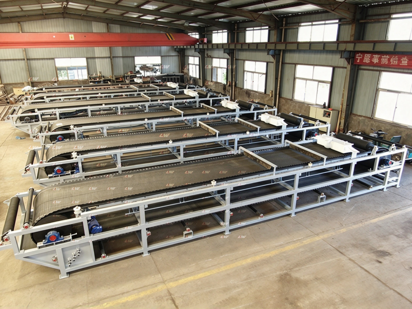 Vacuum belt filter press frames lined up in the Loway assembly shop