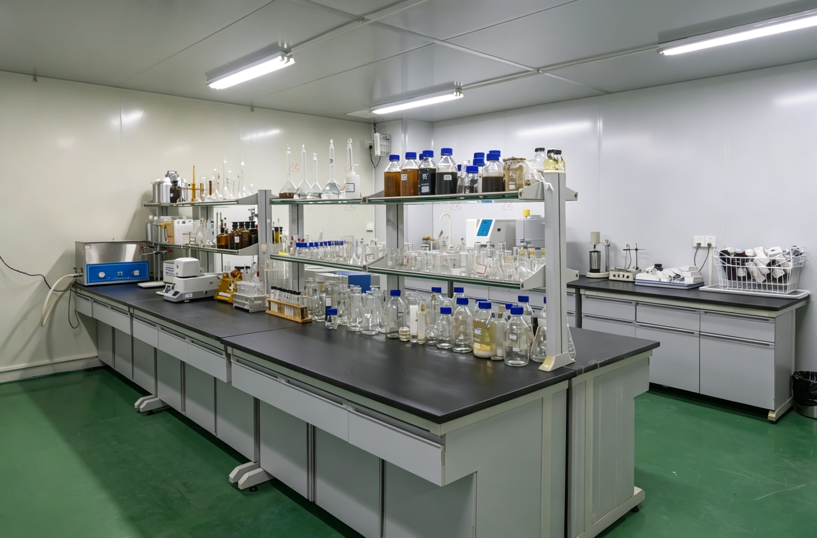 Loway laboratory with benches, glassware and sample bottles used for sludge characterization