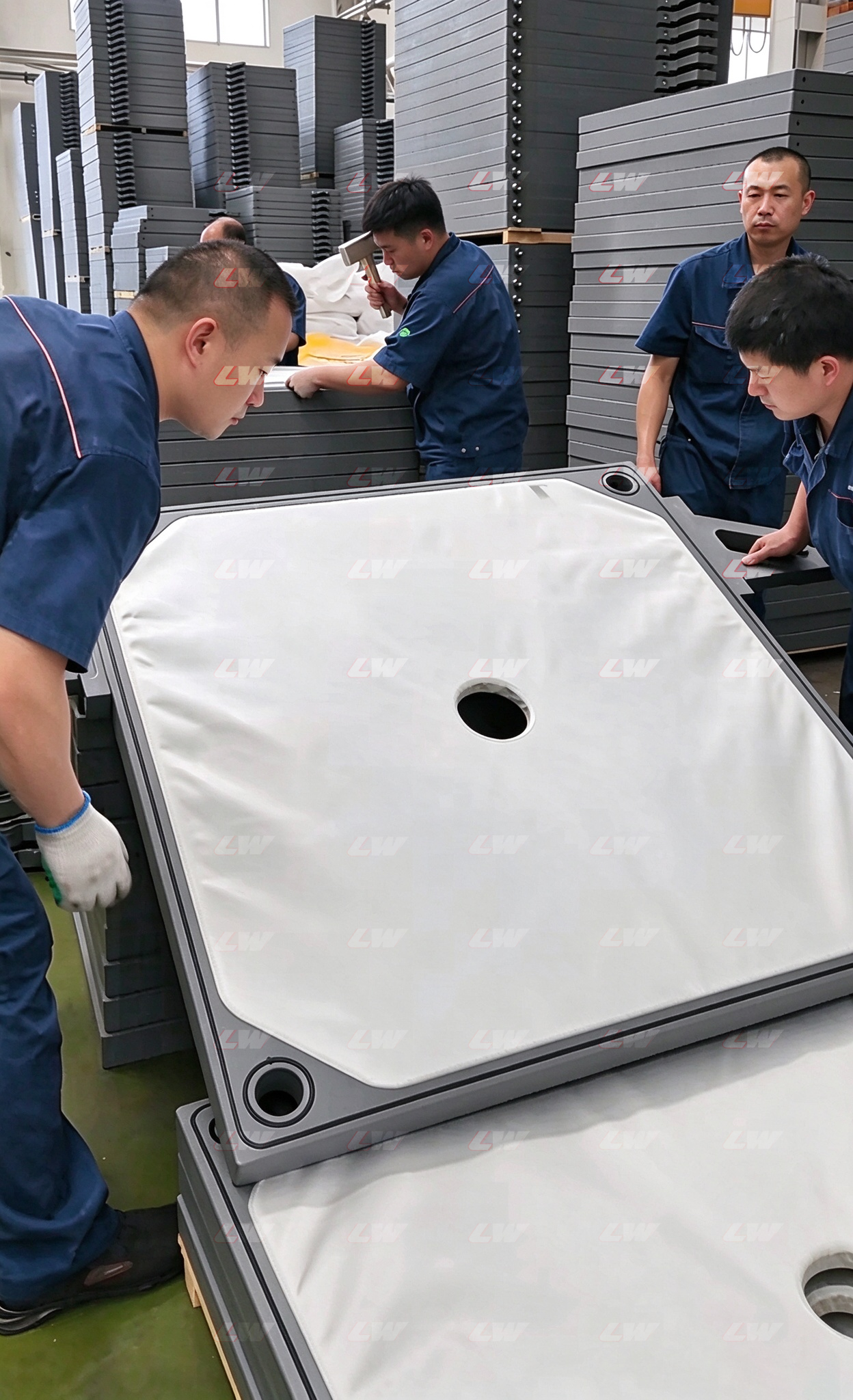 Filter cloth being fitted to a plate at the Loway factory